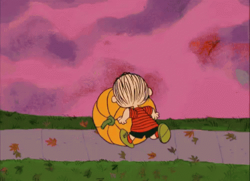 Image of Linus rolling a pumpkin down the sidewalk from a Snoopy animated cartoon
