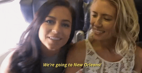 Image of two women on a plane excited to be going to new Orleans
